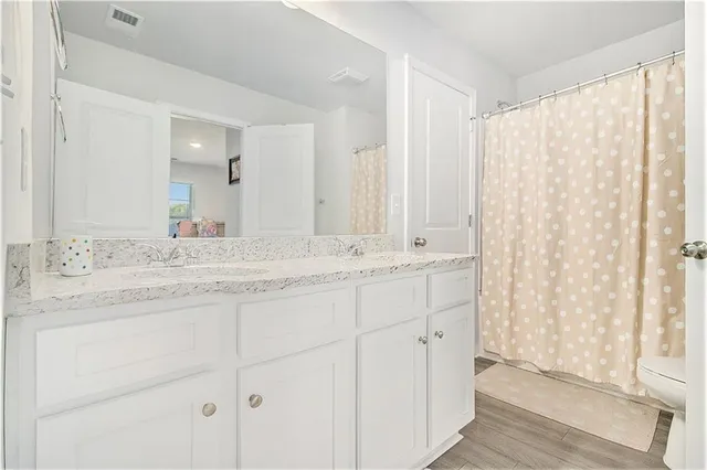 a bathroom with a double vanity sink and a mirror