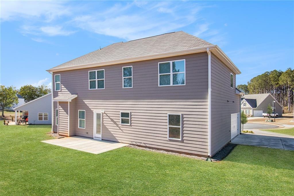 1101 Longleaf Trace Monroe, GA 30656 - Photo 34 of 36 a front view of a house with a garden and yard