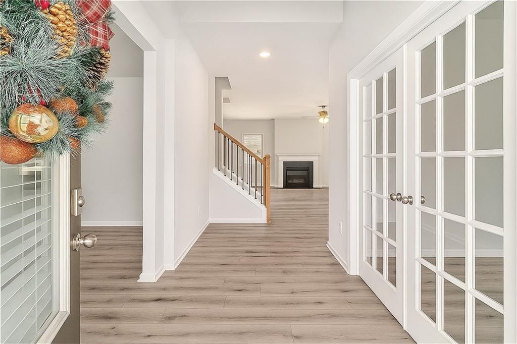 1101 Longleaf Trace Monroe, GA 30656 - Photo 5 of 36 a view of a hallway with wooden floor and staircase