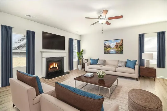 a living room with furniture a fireplace and a flat screen tv