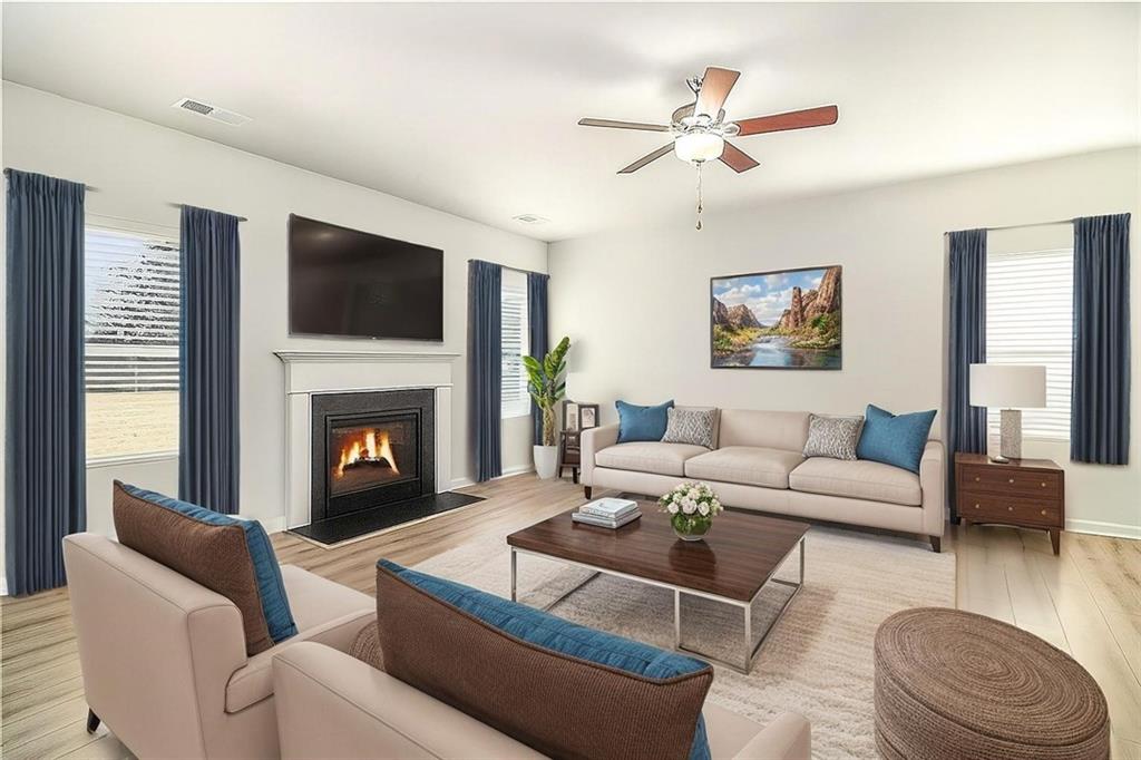 1101 Longleaf Trace Monroe, GA 30656 - Photo 8 of 36 a living room with furniture a fireplace and a flat screen tv