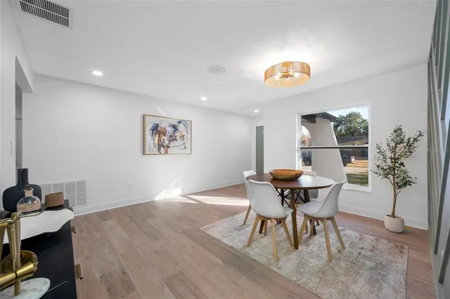 a view of a dining room with furniture and wooden floor