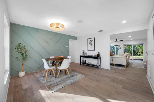 a dining room with furniture and wooden floor