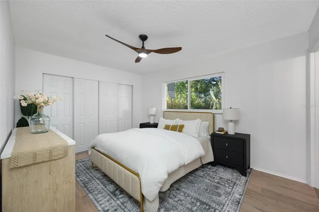 a bedroom with a bed and wooden floor