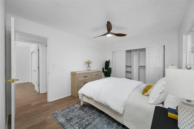 a bedroom with a bed and wooden floor