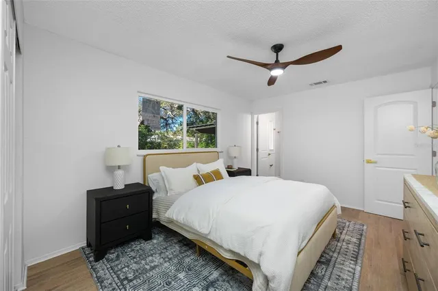 a bedroom with a bed and wooden floor