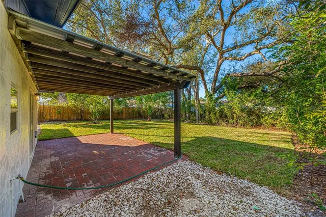 a view of a backyard with swimming pool