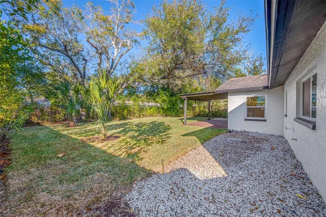 a view of backyard of house with green space