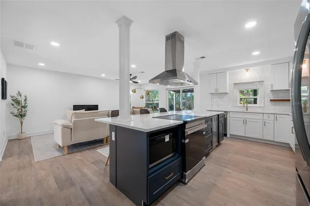 a kitchen with a sink stove and cabinets
