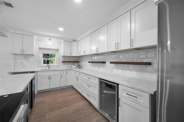 a kitchen with granite countertop cabinets stainless steel appliances and a sink