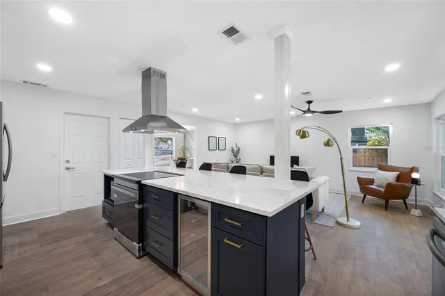 a large kitchen with a table and chairs
