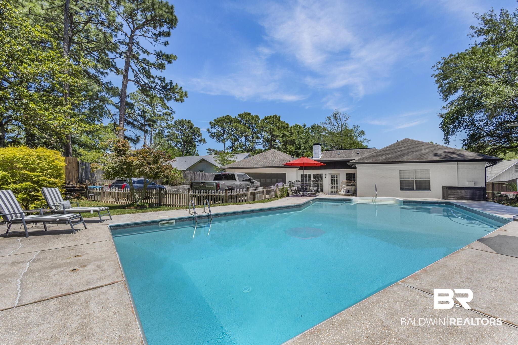 83 Caisson Trace Daphne, AL 36527 - Photo 59 of 63 Expansive backyard featuring a large swimming pool with concrete surround