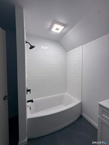 a bathroom with a bathtub and shower
