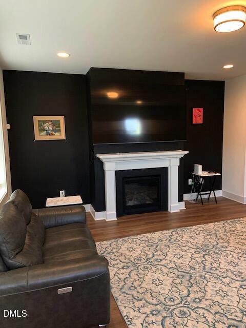 283 Daniel Ridge Road Wendell, NC 27591 - Photo 2 of 9 a living room with furniture a flat screen tv and a fireplace