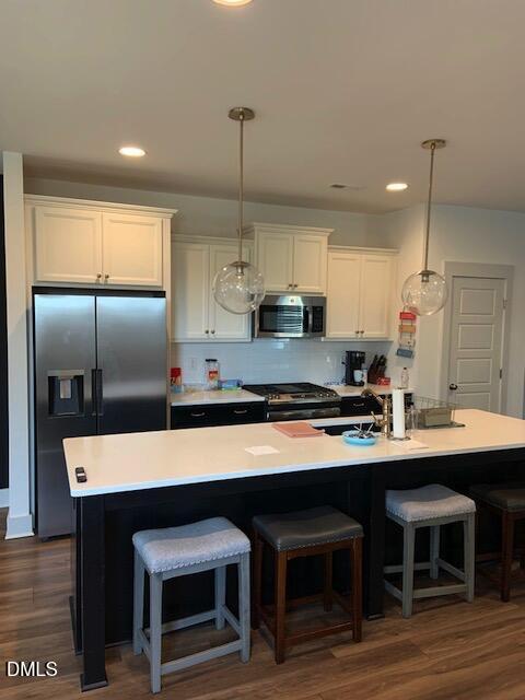 283 Daniel Ridge Road Wendell, NC 27591 - Photo 3 of 9 a large kitchen with a table chairs refrigerator and microwave