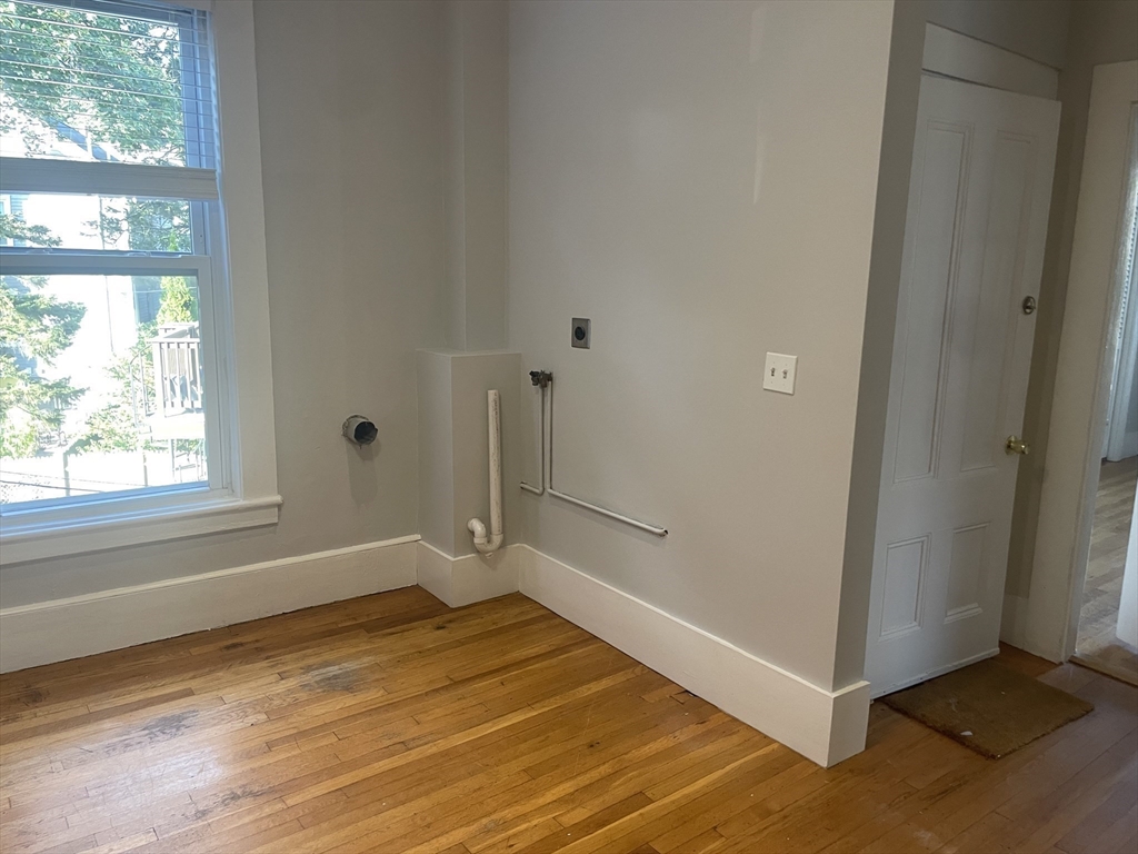 4 Blaney Street, Unit 2 Swampscott, MA 01907 - Photo 21 of 24 a view of a room with wooden floor and windows