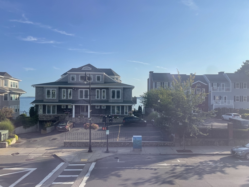 4 Blaney Street, Unit 2 Swampscott, MA 01907 - Photo 24 of 24 a view of a big house with a yard