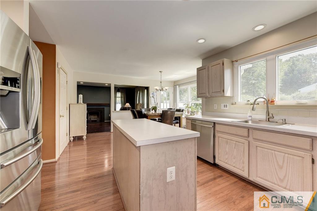 25 Crescent Road Old Bridge, NJ 08857 - Photo 11 of 25 a kitchen with sink a refrigerator and wooden cabinets