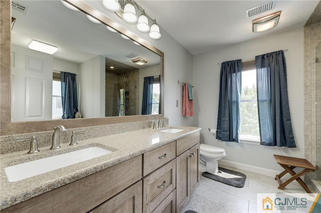 25 Crescent Road Old Bridge, NJ 08857 - Photo 16 of 25 a spacious bathroom with a granite countertop double vanity and a mirror