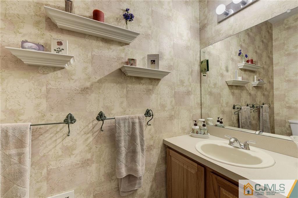 25 Crescent Road Old Bridge, NJ 08857 - Photo 6 of 25 a bathroom with a sink and a mirror