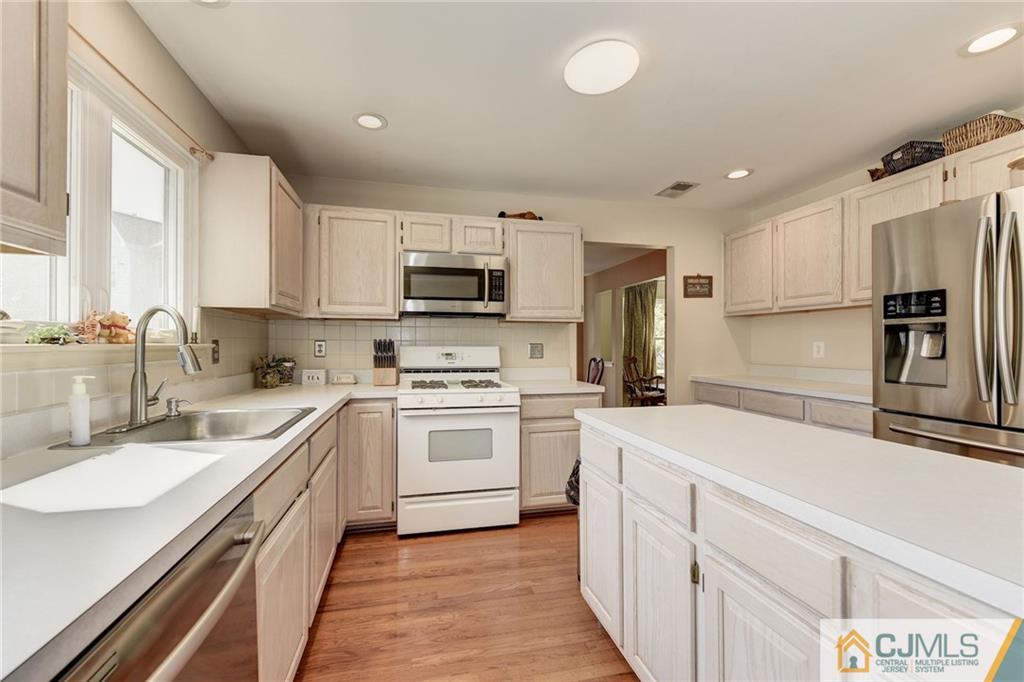 25 Crescent Road Old Bridge, NJ 08857 - Photo 10 of 25 a kitchen with a sink stove oven and refrigerator