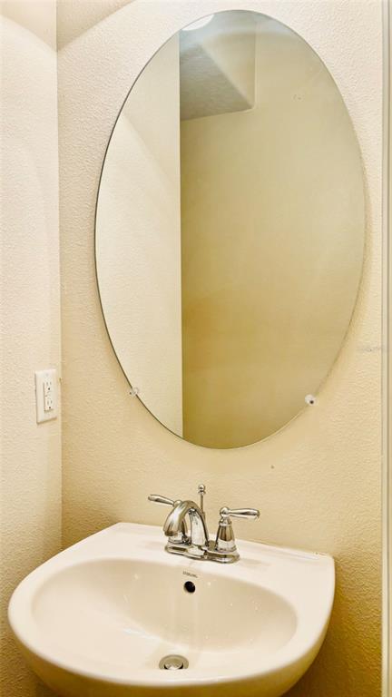 2144 Rookery Lane Sanford, FL 32773 - Photo 16 of 41 a bathroom with a sink and a mirror