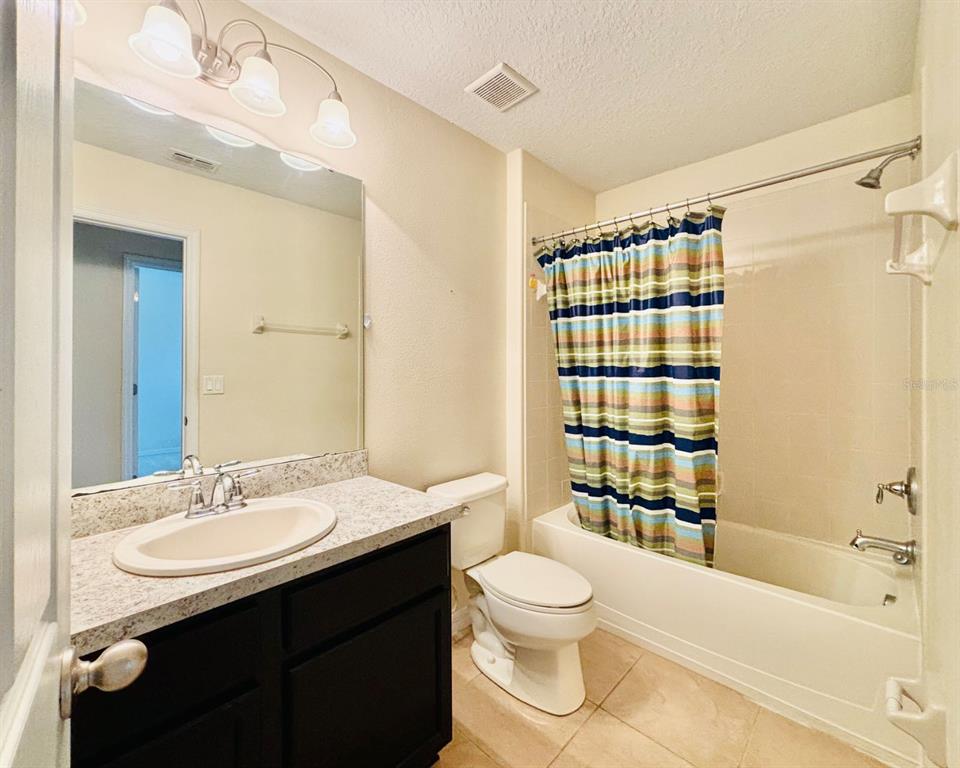 2144 Rookery Lane Sanford, FL 32773 - Photo 30 of 41 a bathroom with a sink a toilet and shower