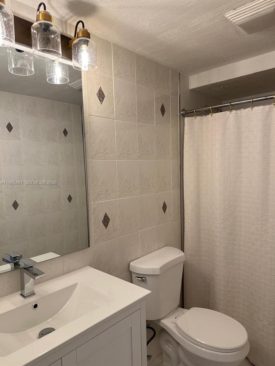 10916 Southwest 70th Terrace Miami, FL 33173 - Photo 13 of 39 a bathroom with a sink toilet and shower