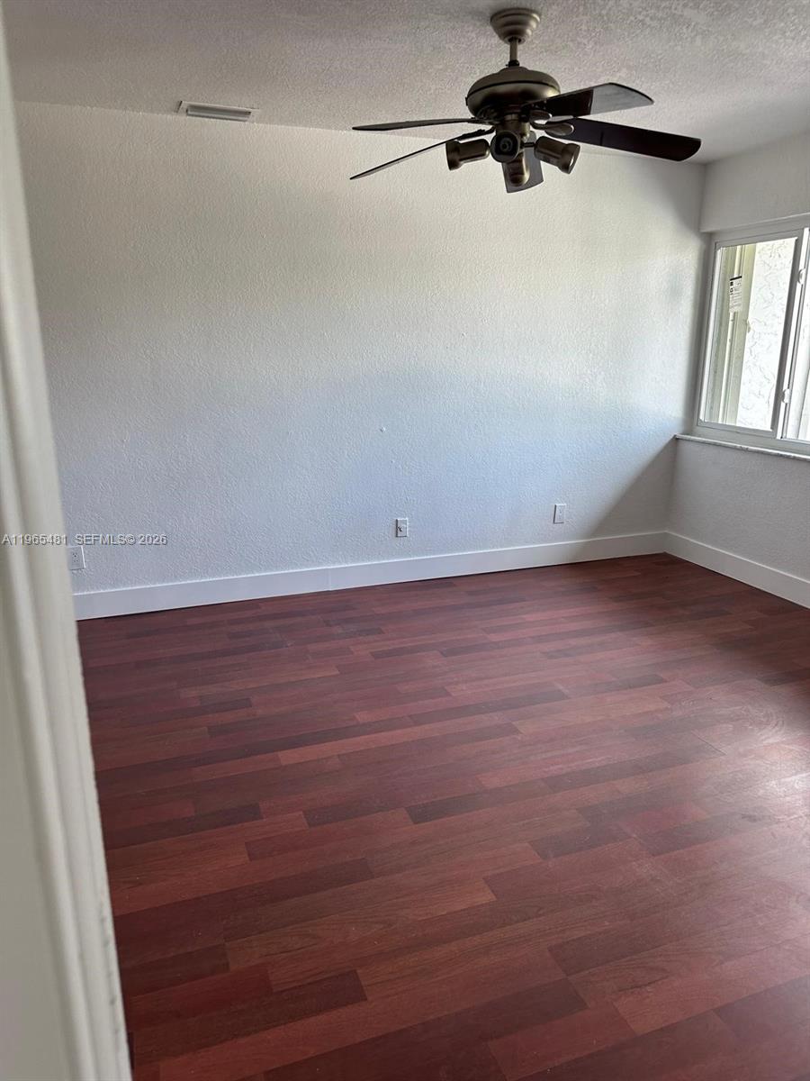 10916 Southwest 70th Terrace Miami, FL 33173 - Photo 19 of 39 a view of a room with wooden floor and windows