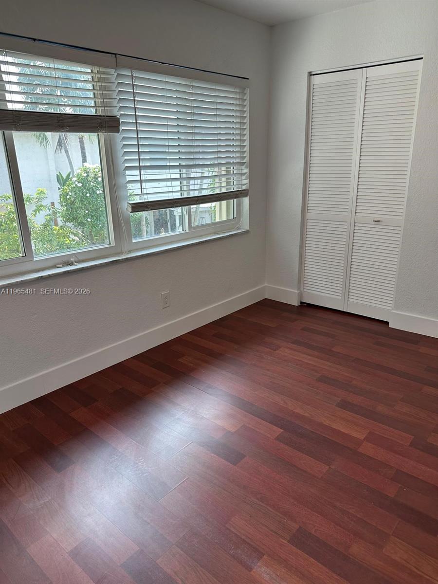 10916 Southwest 70th Terrace Miami, FL 33173 - Photo 22 of 39 an empty room with wooden floor and windows