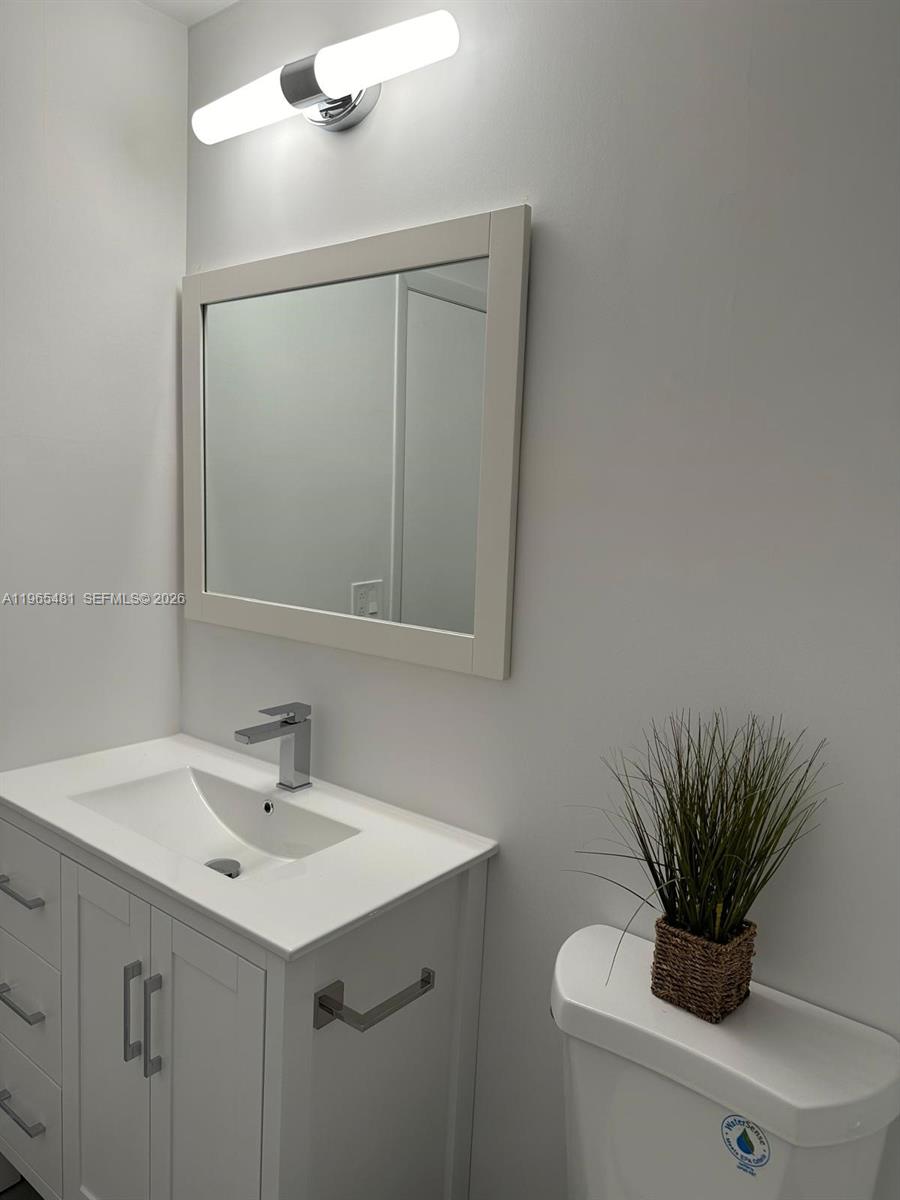 10916 Southwest 70th Terrace Miami, FL 33173 - Photo 25 of 39 a bathroom with a sink a mirror and vanity