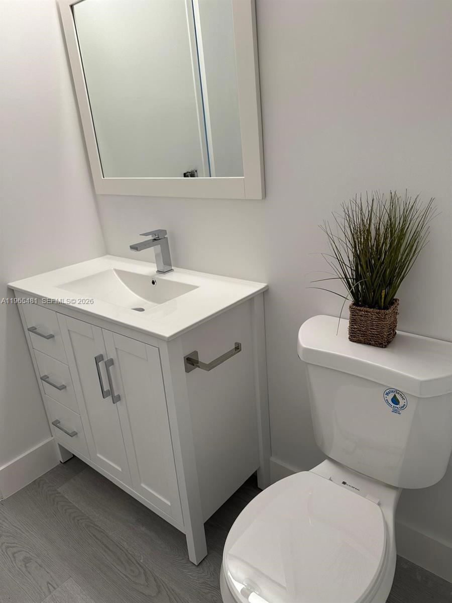 10916 Southwest 70th Terrace Miami, FL 33173 - Photo 26 of 39 a bathroom with a toilet a sink and a mirror