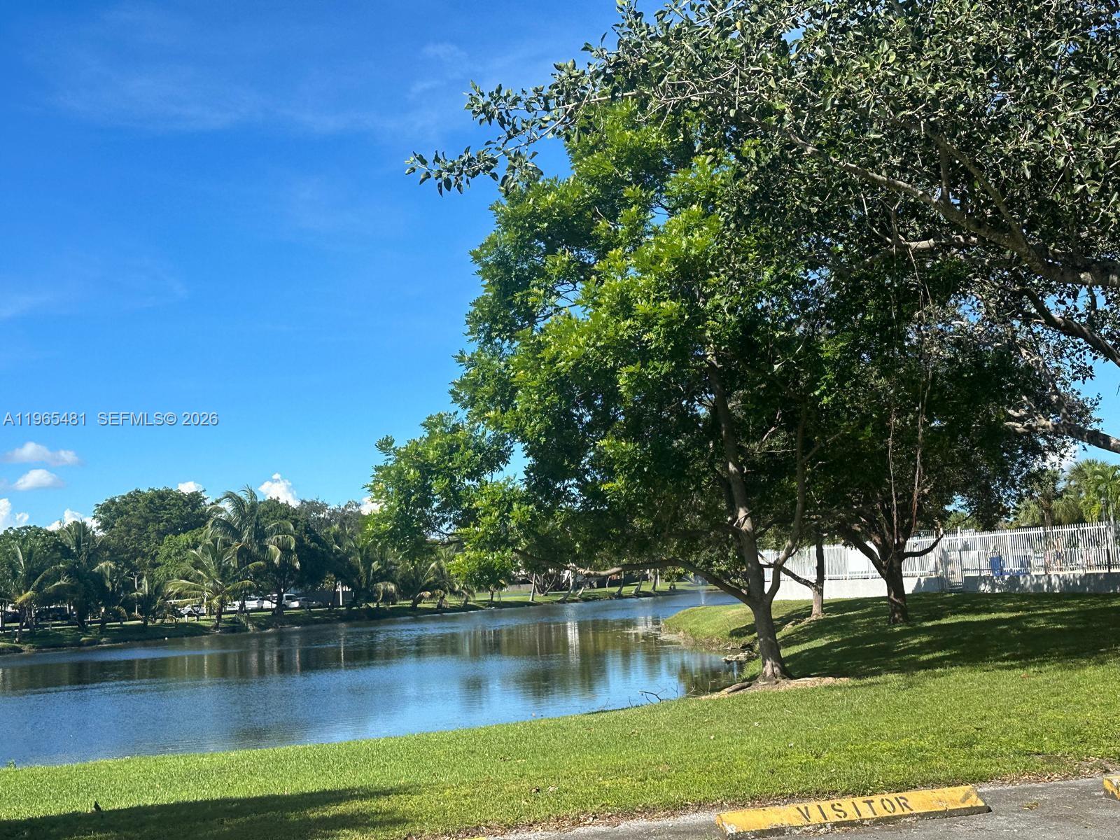 10916 Southwest 70th Terrace Miami, FL 33173 - Photo 34 of 39 a view of a lake with houses in the background