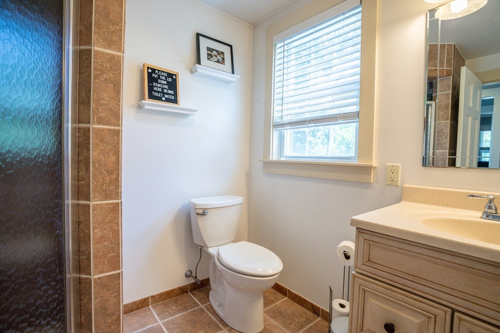3642 Pawtucket Avenue Riverside, RI 02915 - Photo 17 of 39 a bathroom with a toilet a sink and a window