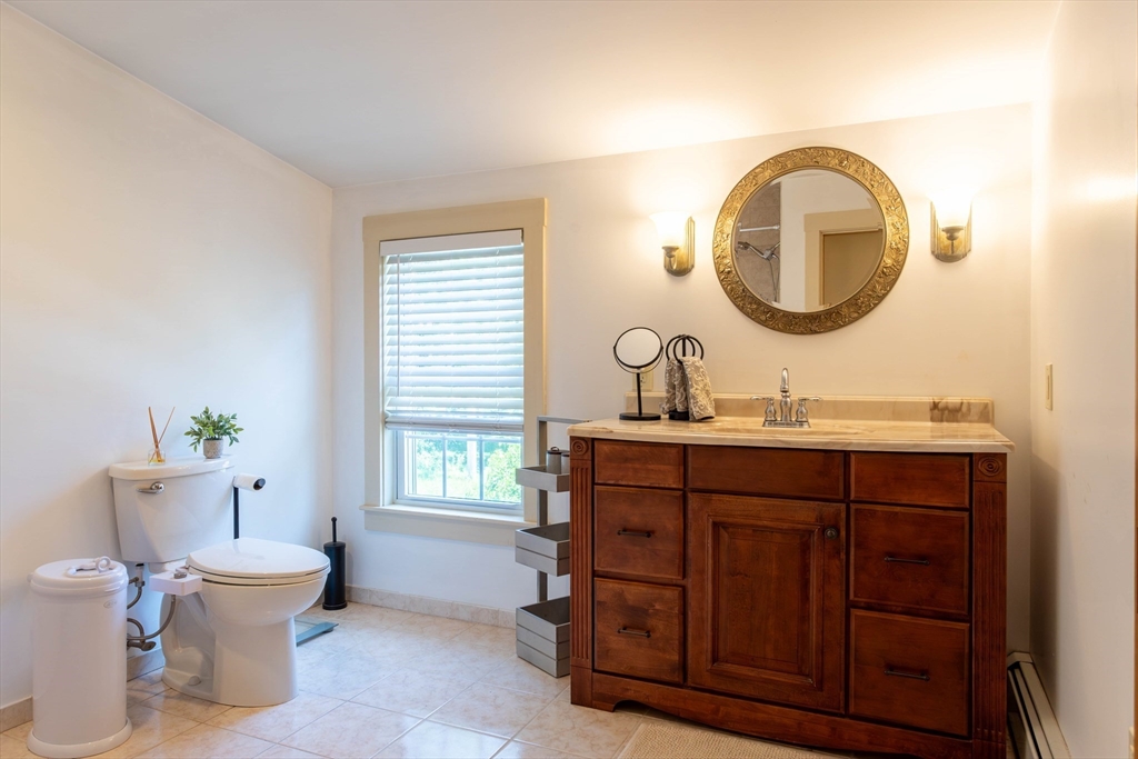 3642 Pawtucket Avenue Riverside, RI 02915 - Photo 35 of 39 a bathroom with a toilet a sink and a mirror