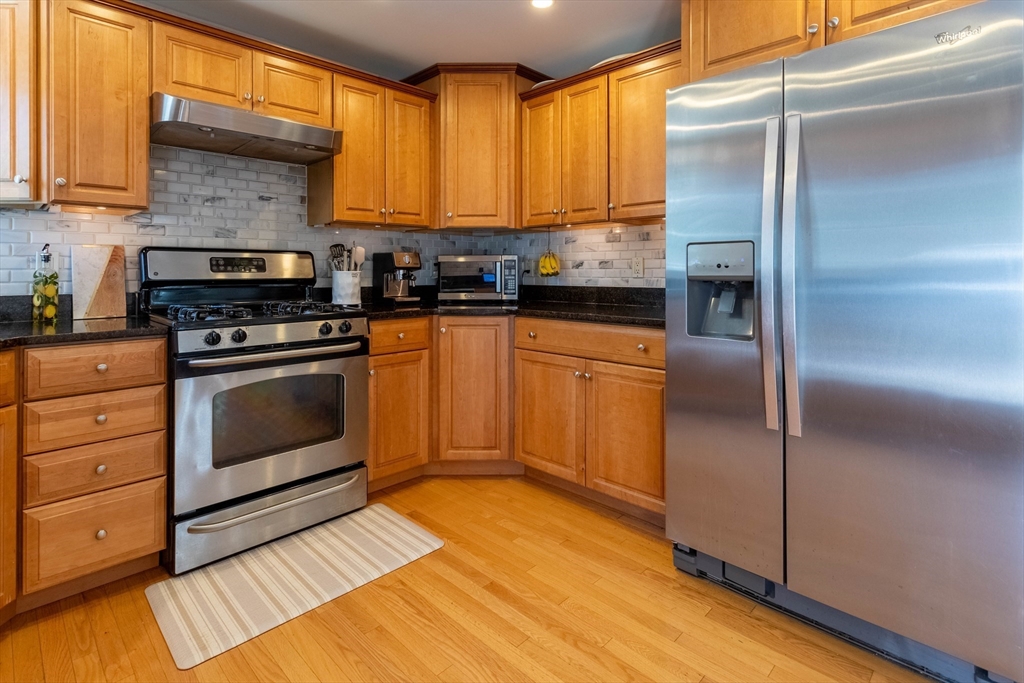 3642 Pawtucket Avenue Riverside, RI 02915 - Photo 4 of 39 a kitchen with stainless steel appliances granite countertop a stove a refrigerator and a microwave