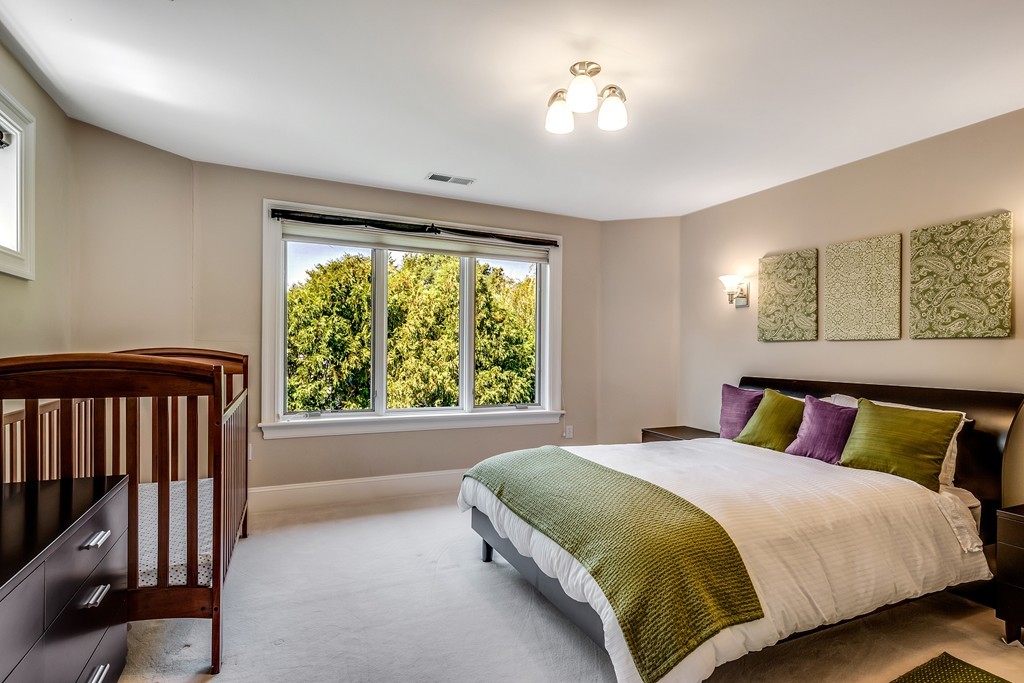 36 Sky View Circle Newton, MA 02459 - Photo 20 of 29 a bedroom with a large bed and a window
