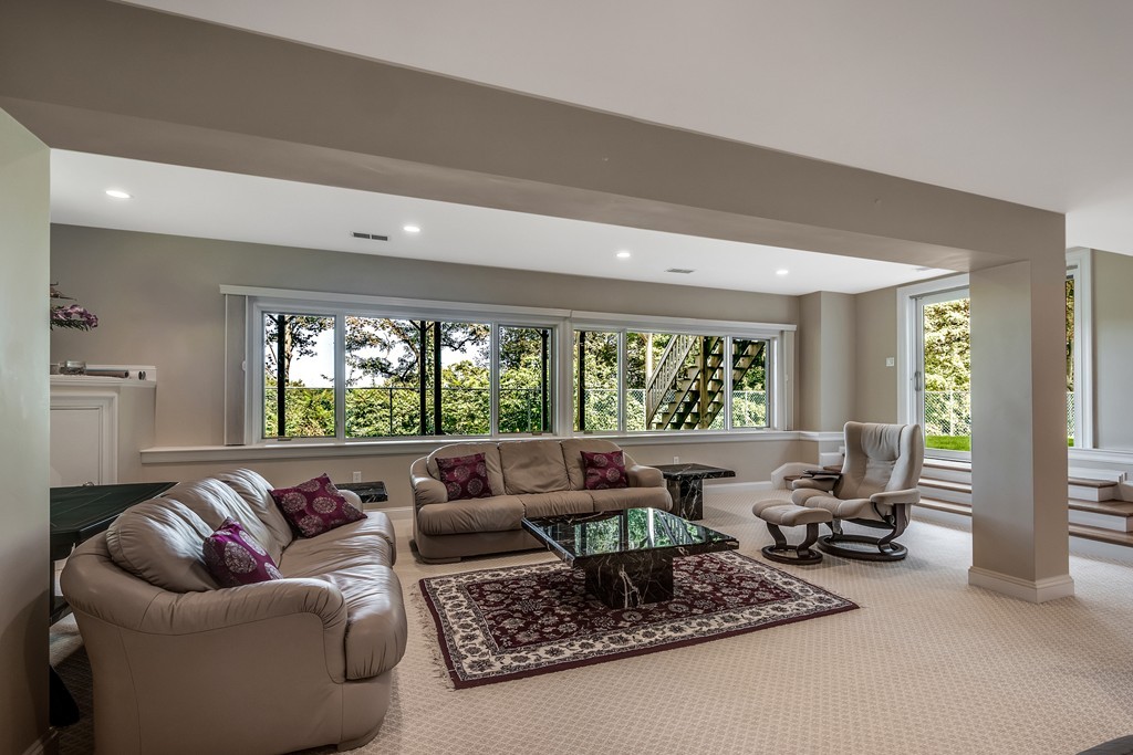 36 Sky View Circle Newton, MA 02459 - Photo 23 of 29 a living room with furniture and a large window