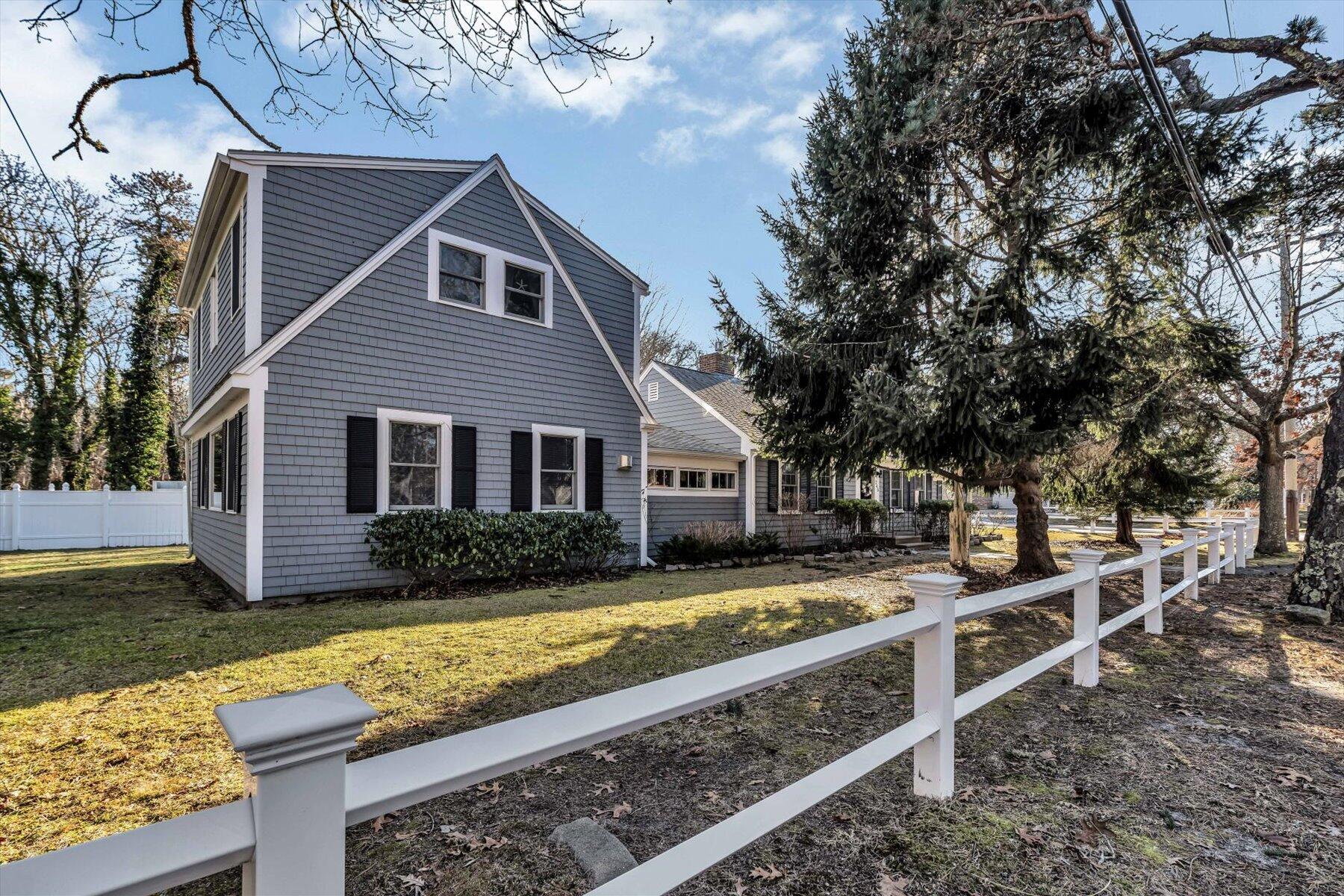 245 Lower County Road Harwich Port, MA 02646 - Photo 1 of 42 a front view of a house with garden