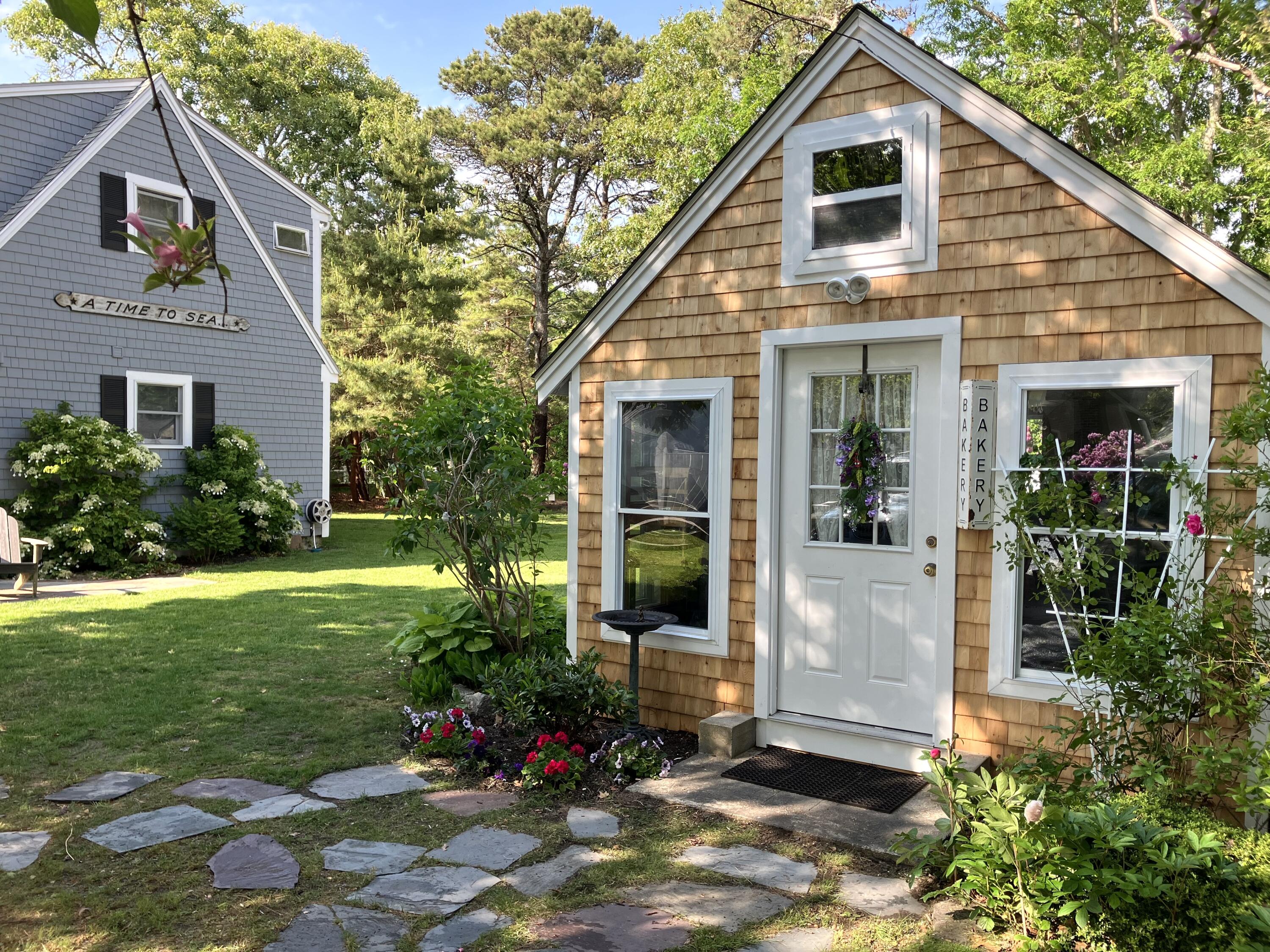 245 Lower County Road Harwich Port, MA 02646 - Photo 2 of 42 a view of a house with yard and garden