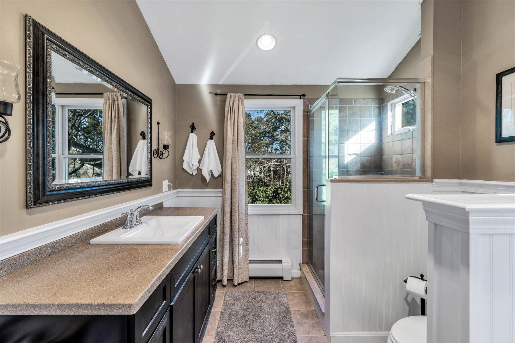 245 Lower County Road Harwich Port, MA 02646 - Photo 33 of 42 a en suite bathroom with a granite countertop sink and a mirror
