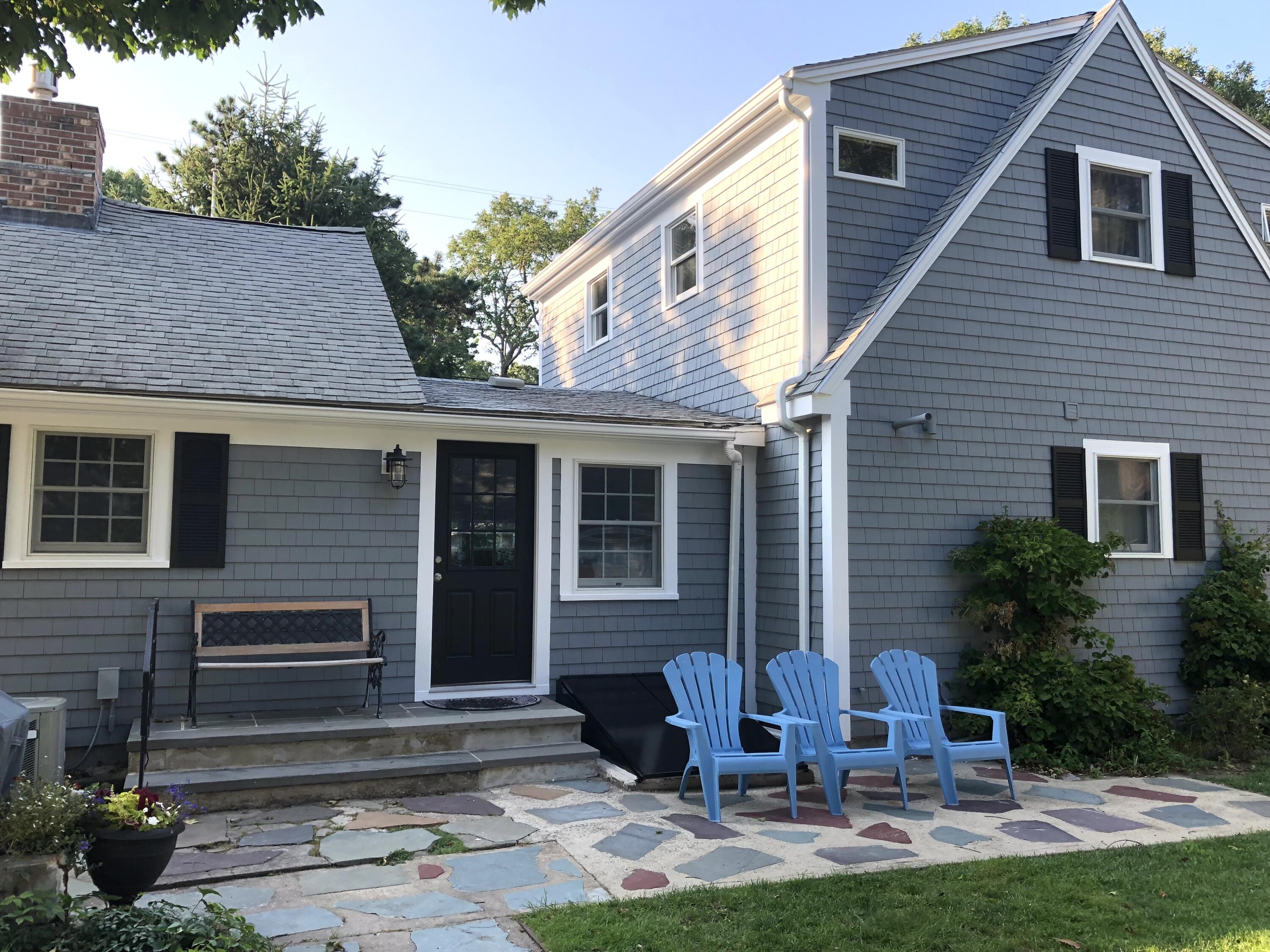 245 Lower County Road Harwich Port, MA 02646 - Photo 4 of 42 a view of backyard with table and chairs and potted plants