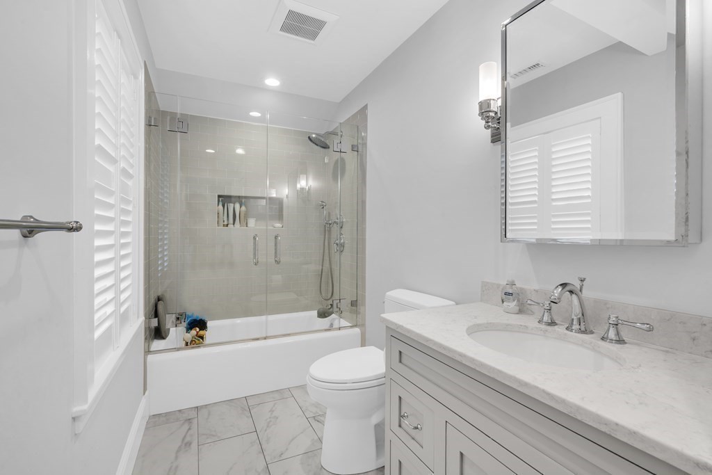 2 Hillcrest Road Marblehead, MA 01945 - Photo 30 of 38 a bathroom with a granite countertop sink toilet a large mirror a bathtub and shower