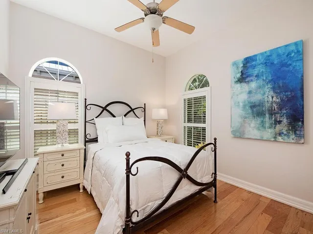 a bedroom with bed and a window