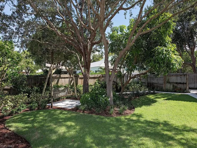 a view of a backyard with large trees