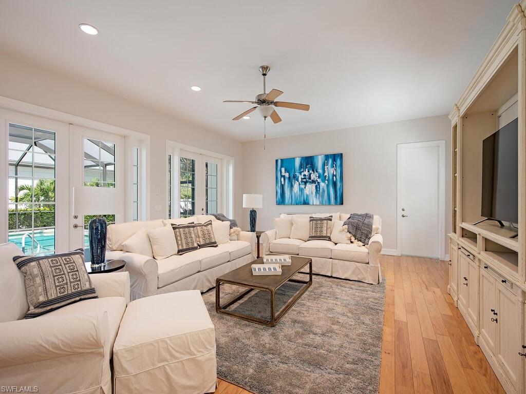 431 1st Avenue North Naples, FL 34102 - Photo 6 of 19 a living room with furniture ceiling fan and a wooden floor