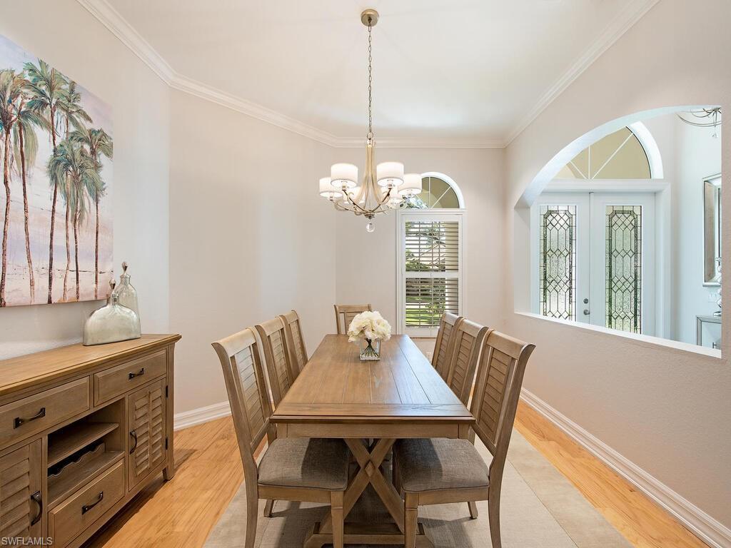 431 1st Avenue North Naples, FL 34102 - Photo 10 of 19 a view of a dining room with furniture window and wooden floor