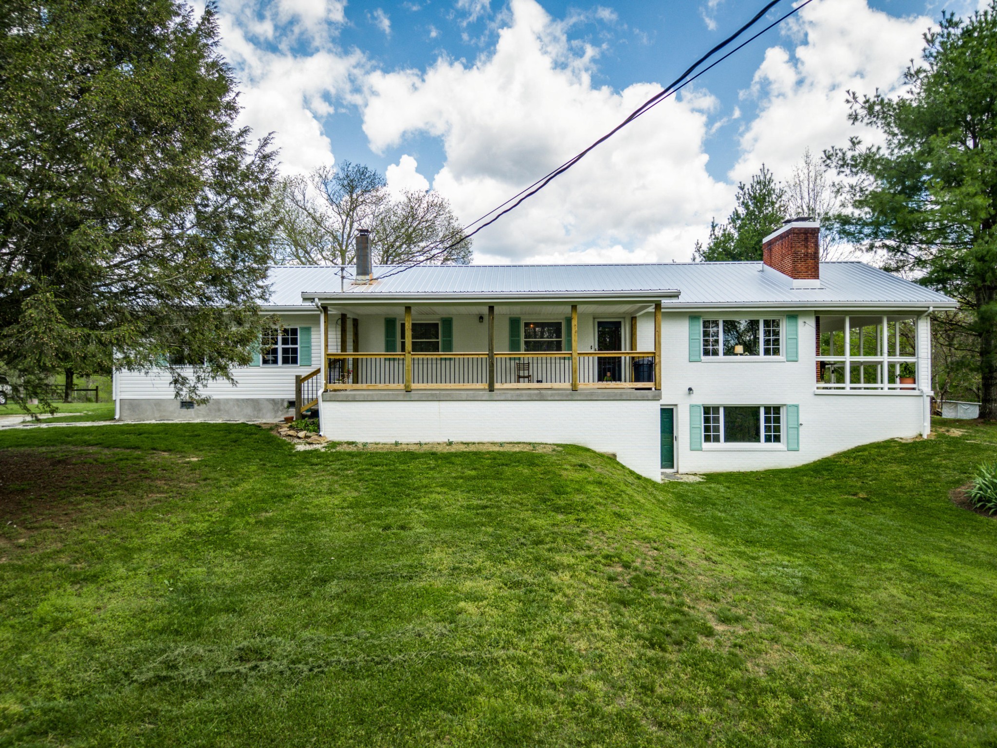 144 Meister Hills Road Deer Lodge, TN 37726 - Photo 1 of 40 a front view of a house with a yard