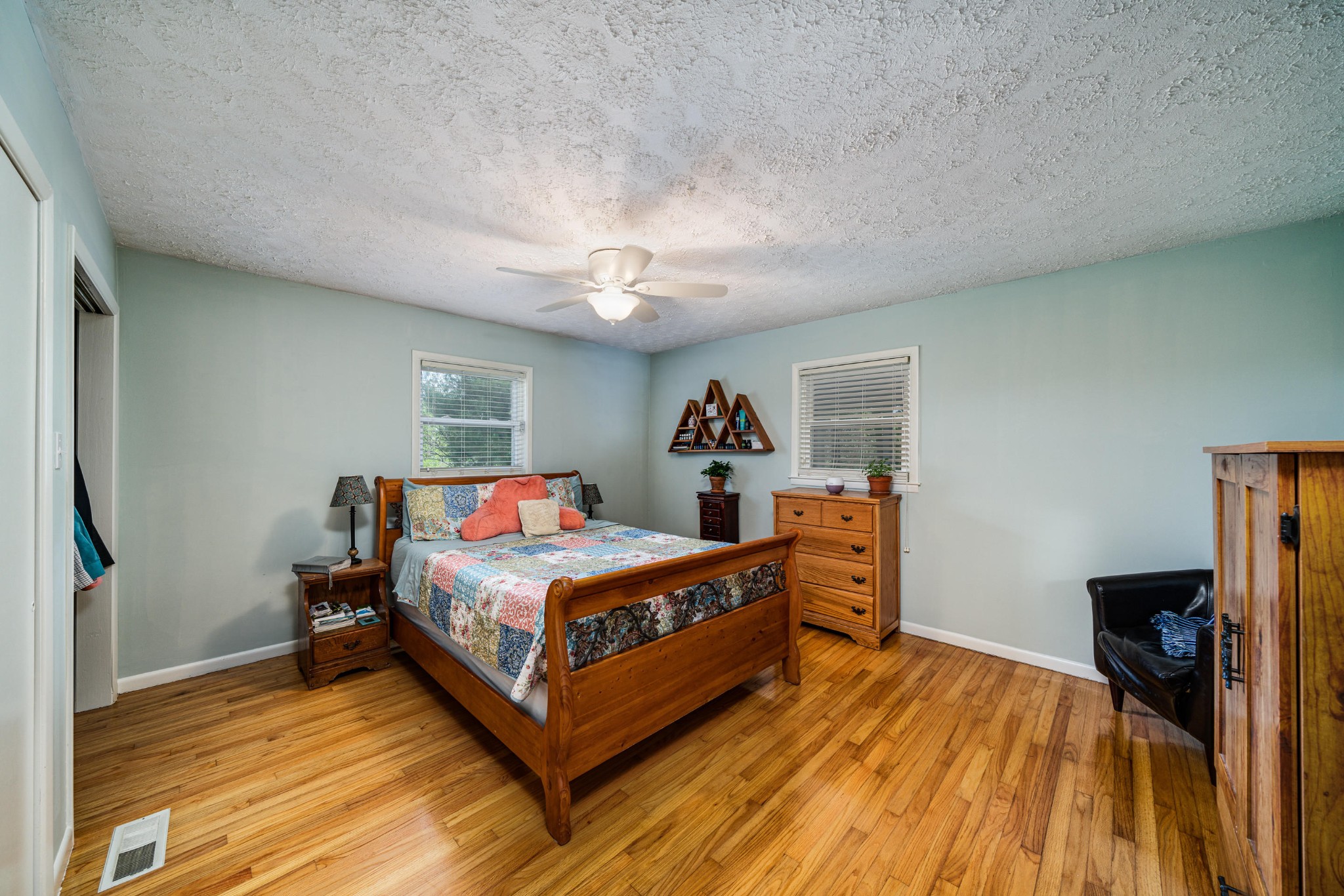144 Meister Hills Road Deer Lodge, TN 37726 - Photo 9 of 40 a bedroom with a bed and a chandelier