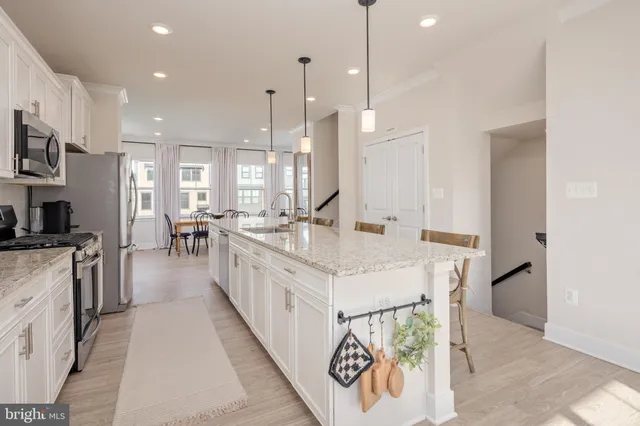 a large white kitchen with lots of counter space and a sink